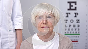 Sad elderly woman disappointed with diagnosis after vision examination, health