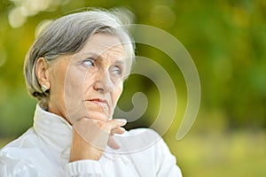 Sad eldery woman in park