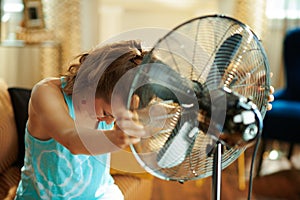 Sad elegant woman showing victory suffering from summer heat