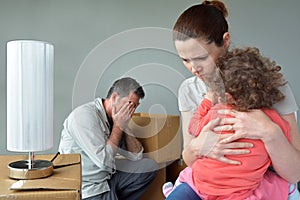 Sad evicted family worried relocating house.