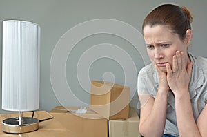 Sad evicted woman worried relocating house photo