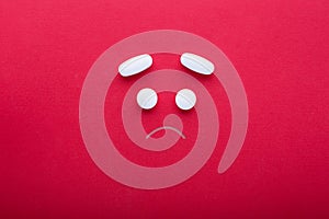 Sad face made of pills