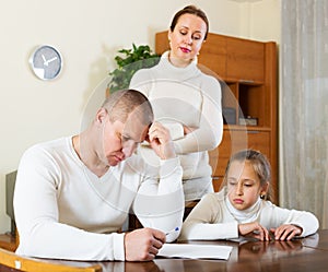 Sad family with documents having problems