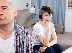 Sad family having difficulties in the living room at home