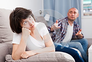 Sad family having difficulties in the living room at home