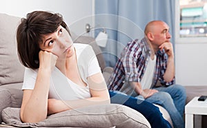 Sad family having difficulties in the living room at home