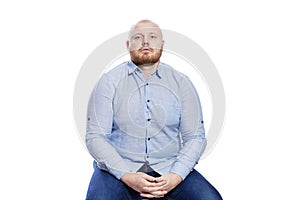 Sad fat red man with a beard. The problem of excess weight. Isolated on a white background