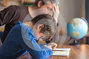 Sad father tired about sons failure on mathematics homework