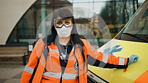 Sad female paramedic stares at you. Writing on clothes means Urgent care