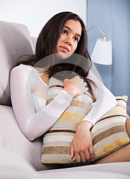 sad female sitting with pillow