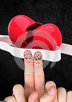 Sad finger couple with red broken heart