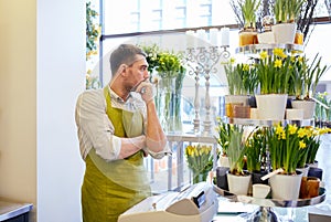 Sad florist man or seller at flower shop counter