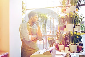 Sad florist man or seller at flower shop counter