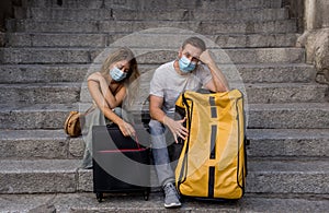Sad and frustrated tourist couple not able to travel abroad due to post covid travel restrictions