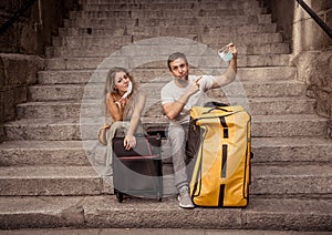 Sad and frustrated tourist couple not able to travel abroad due to post covid travel restrictions