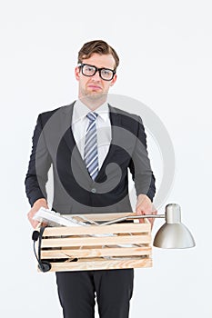 Sad geeky businessman holding box of his things