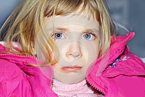 Sad gesture in blond little girl portrait