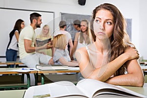 Sad girl in college classroom