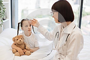 Sad girl feeling bad so asking nurse to checking temperature