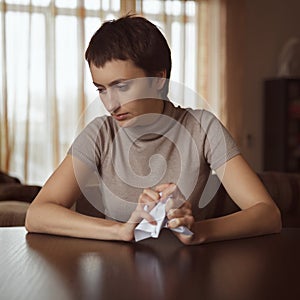 Sad girl holding a crumpled letter