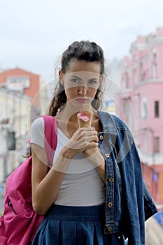 Sad girl holding ice cream in hand