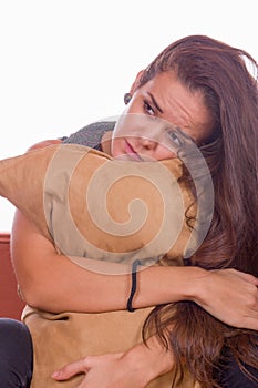 Sad girl hugging pillow