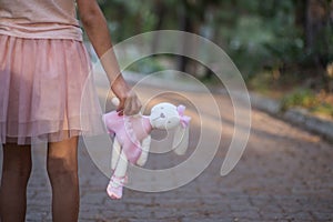 Sad girl hugging teddy bear sadness alone in green garden park. Lonely girl feeling sad unhappy walking outdoors with