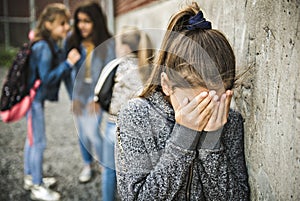 A sad girl intimidation moment on the elementary Age Bullying in Schoolyard