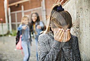 A sad girl intimidation moment on the elementary Age Bullying in Schoolyard