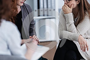 Sad girl with psychotherapist. Women`s issues support group concept