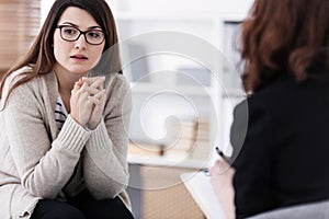 Sad girl with psychotherapist. Women`s issues support group concept