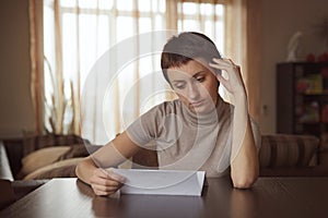 Sad girl reading a letter