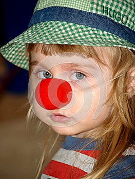 Sad girl with red clown nose