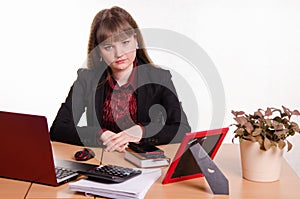 Sad girl sitting at office desk