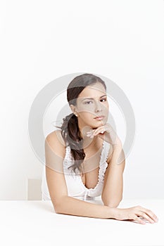 Sad girl sitting over white background