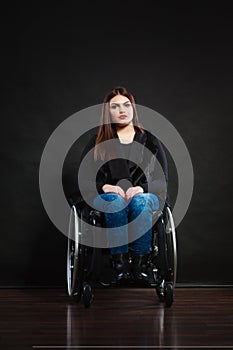 Sad girl on wheelchair.