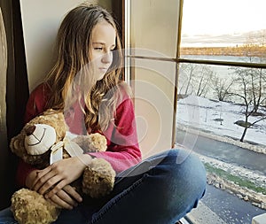 Sad girl window teddy bear