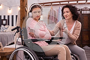 Sad handicapped girl listening to music