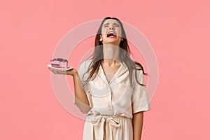 Sad and heartbroken lonely young girl broke-up with boyfriend crying and sobbing, holding cake, eating to ease pain