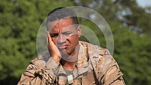 Sad Hispanic Male Soldier Wearing Camo
