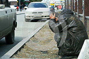 Sad homeless man in depression on city street