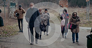 Sad Homeless Refugees Walking While Migrating During War.