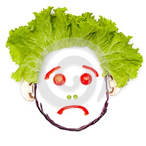 Sad human head made of vegetables