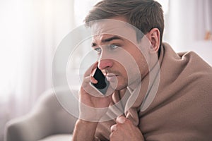 Sad ill man making a call