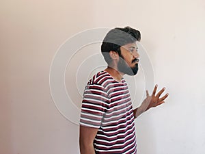 Sad Indian beard man, showing helpless gesture with arm