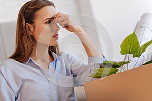 Sad jobless woman trying not to cry while sitting at home