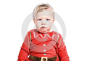 Sad kid dressed as Santa Claus. Christmas boy