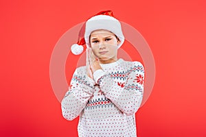 Sad kid in sweater and santa