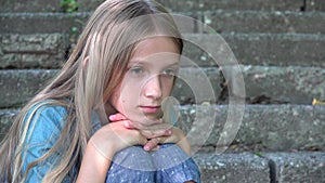 Sad kid, unhappy child, thoughtful bullied teenager girl outdoor in park, children sadness, depression portrait of adolescents