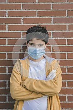 Sad kid wearing medical mask